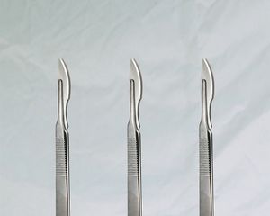 Three scalpels on a background