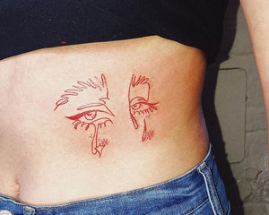 Woman shows off side tattoo of eyes