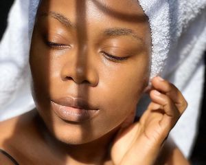 woman with glowing skin in towel