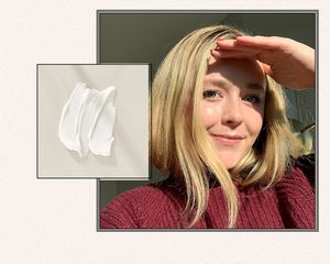 woman looking into sunlit window 