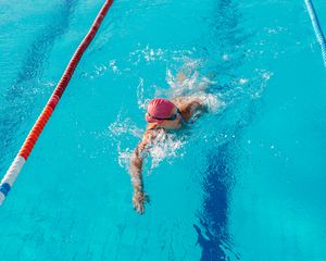 Woman swimming a lap in a pool.