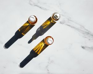 non-comedogenic oil vials on marble counter top