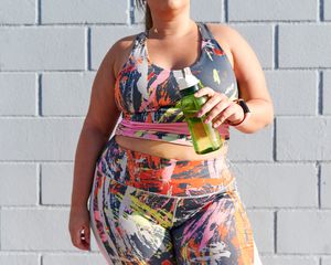 Woman holding a drink after a workout