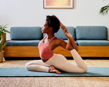 person does yoga pose in living room