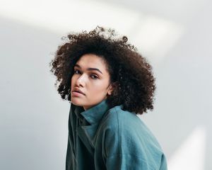 Woman with curly hair, looking at the camera