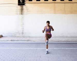 Woman jumping to the side outdoors