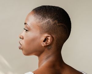 Woman looks off to the side, her ear visible