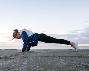 Woman performing a plank outdoors
