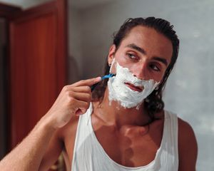Man shaving his face