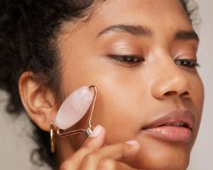 Woman using jade roller