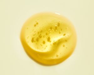 Drop of oil or serum product on neutral background