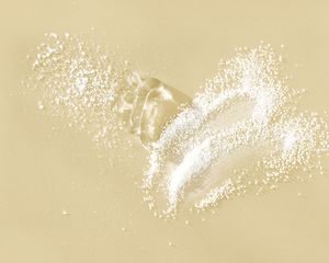 gel and white powder on yellow surface