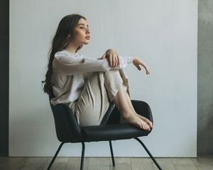 Woman sitting in a chair looking into the distance