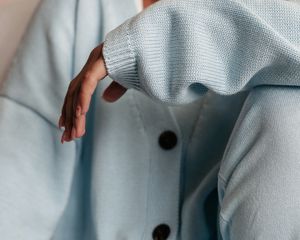 Woman in oversized blue cardigan