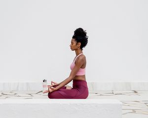person meditating on patio outside