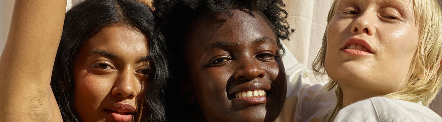three women smiling in sunshine