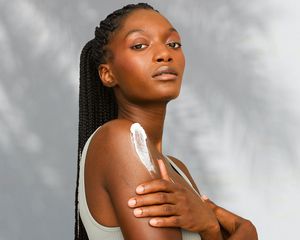 Woman with a swatch of sunscreen on her arm.