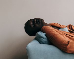 Tired woman reclining on a couch.
