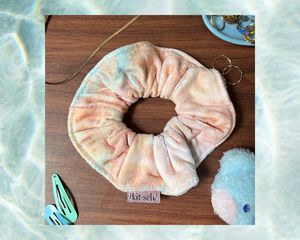 Orange and blue Kitsch towel scrunchie with coordinating accessories and pool background