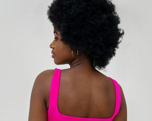 woman in pink tank top with natural hair