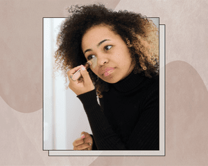 Woman Applying Concealer to Herself Designed on an Abstract Background