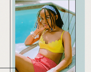 BIPOC Woman Sitting by a Pool in a Retro Inspired Bathing Suit 