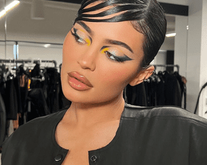 Kylie Jenner Wearing piecey side bangs and kylie cosmetics Batman eye shadow