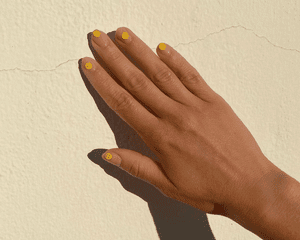 woman with smiley face manicure