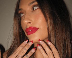 hailey bieber with a red french tip manicure